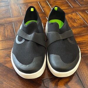 OOFOS Black and White Slip-On Sneakers.